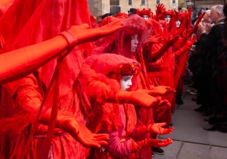Extinction Rebellion's 'Red Rebels' paying tribute before 'Mother Earth's' funeral bier, Bath '24.