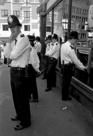 Police at ATM, Islington, London.